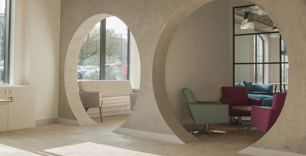 Open concrete tube meeting space with natural light