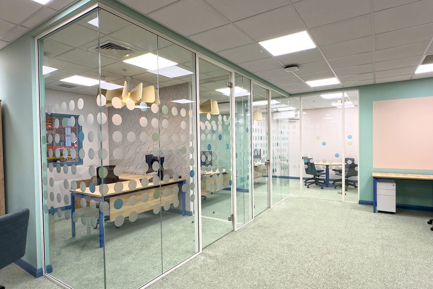 glass meeting rooms installed under warehouse mezzanine floor